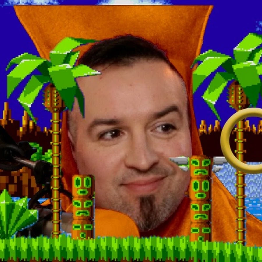 Mike B smiling against a colorful pixel-art game backdrop